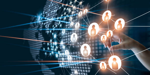 Hand selecting a digital human icon from a global interconnected network, representing communication, data sharing, and online collaboration.