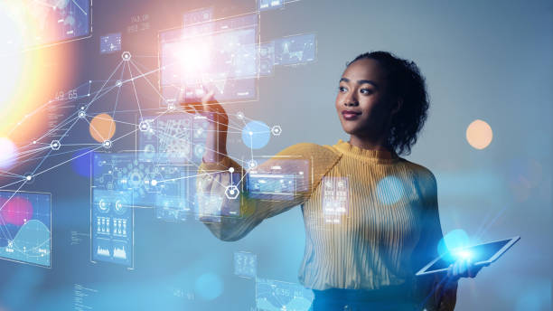 Woman using tablet and interacting with futuristic digital data interface.